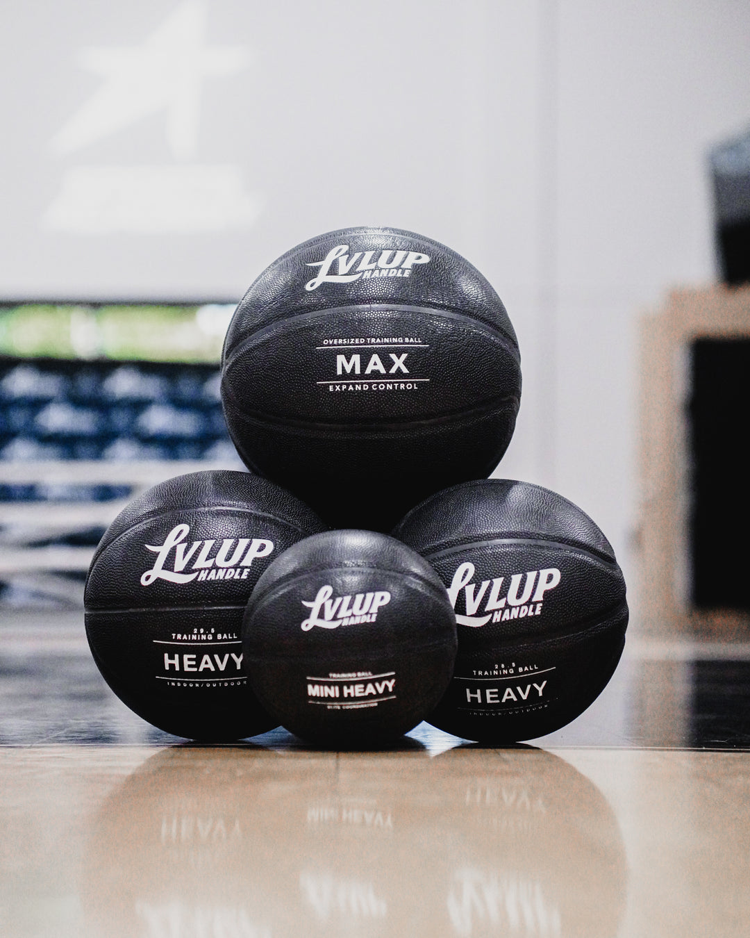 Stack of black training balls with 'LYLUP' branding on a reflective surface.